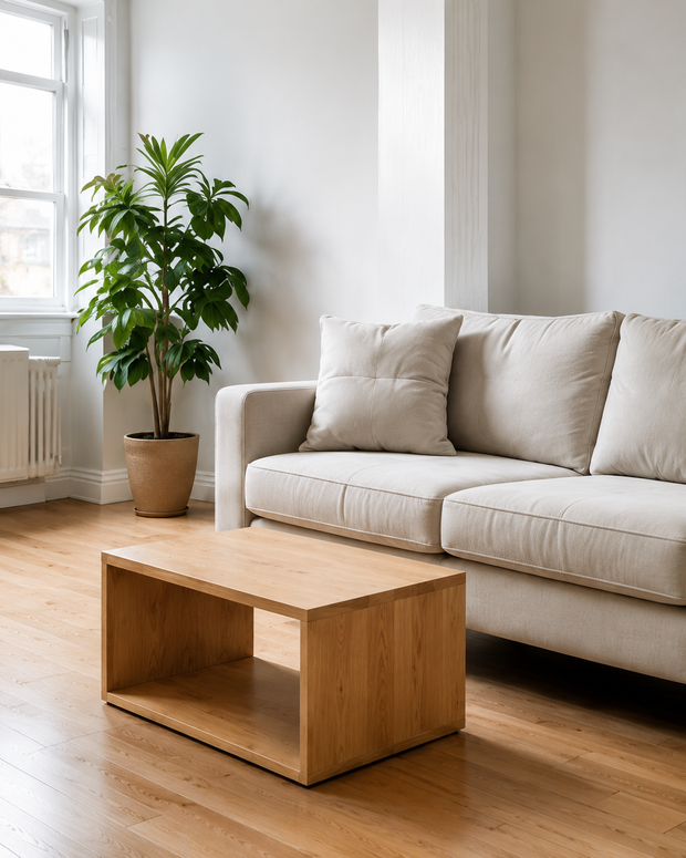 A sofa, cushions and a wooden coffee table in a cleared living room in Malta